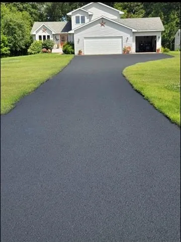 Long winding driveway leading to ranch home after sealing